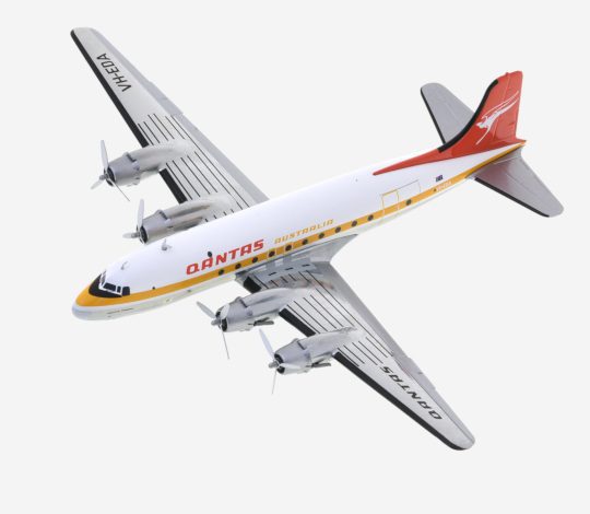Top view of Herpa HE570855 - 1/200 scale diecast model Douglas DC-4, registration VH-EDA, named "Pacific Trader" in the Ochre livery of Qantas Airways.