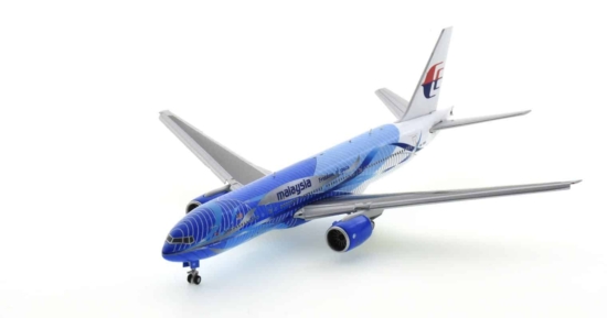 Front port side view of JC Wings JC4MAS485A / XX4485A -  1/400 scale diecast model B777-300 with flaps down of registration 9M-MRD in Malaysia Airlines "Heliconia - Freedom of Space" livery.