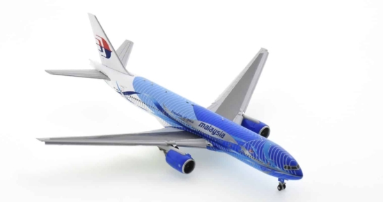 Front starboard side view of JC Wings JC4MAS485A / XX4485A -  1/400 scale diecast model B777-300 with flaps down of registration 9M-MRD in Malaysia Airlines "Heliconia - Freedom of Space" livery.