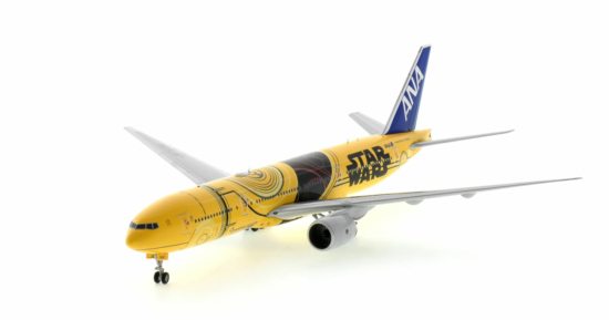 Front port side view of the 1/200 scale diecast model Boeing 777-200ER of registration JA743A in All Nippon Airways (ANA) Star Wars "C-3PO" livery - JC Wings EW2772005